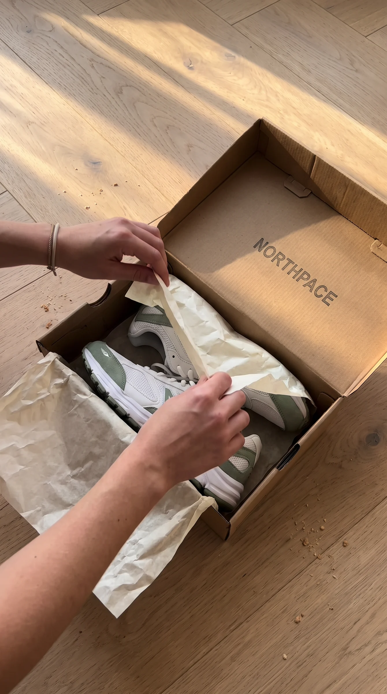 Hands unboxing Northpace sneakers